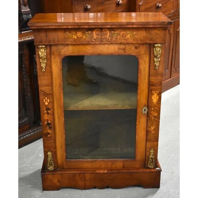 For sale is a fine quality Victorian walnut and marquetry pier cabinet, in good condition for its age, showing minor signs...