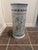 This is a hand-painted porcelain umbrella stand created and manufactured by the Henriot Quimper Faience factory, a...