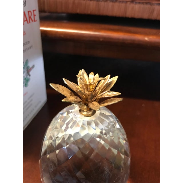 Unique Swarovski Crystal and brass pineapple paperweight. Measures about 5” tall x 3.5” wide.