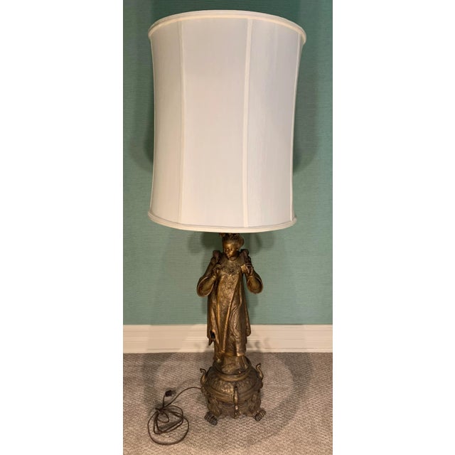 Vintage figural brass lamp of robed nobel woman on brass stand.. Double medium base sockets with pull chains and thumb...