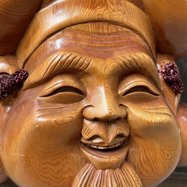 Atmospheric pair of hand-carved wooden masks with a warm, honey-toned sheen. Dimensions (each): height 21.5 cm, width 20...