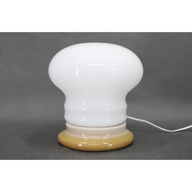 This refined czechoslovak midcentury table lamp dates from the 1960s and exemplifies the restrained material palette and...