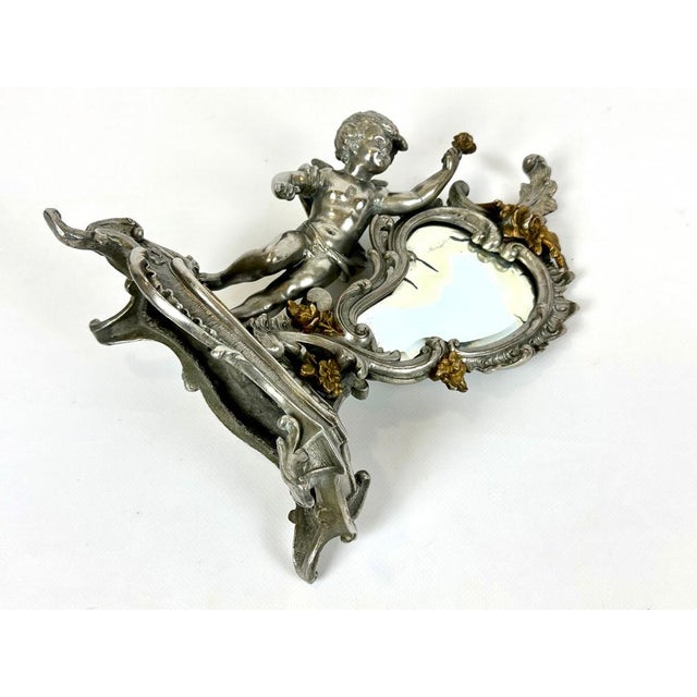 An antique French mirror from the 19th century. The frame features exquisite Louis XV-style cherub decoration. The mirror...