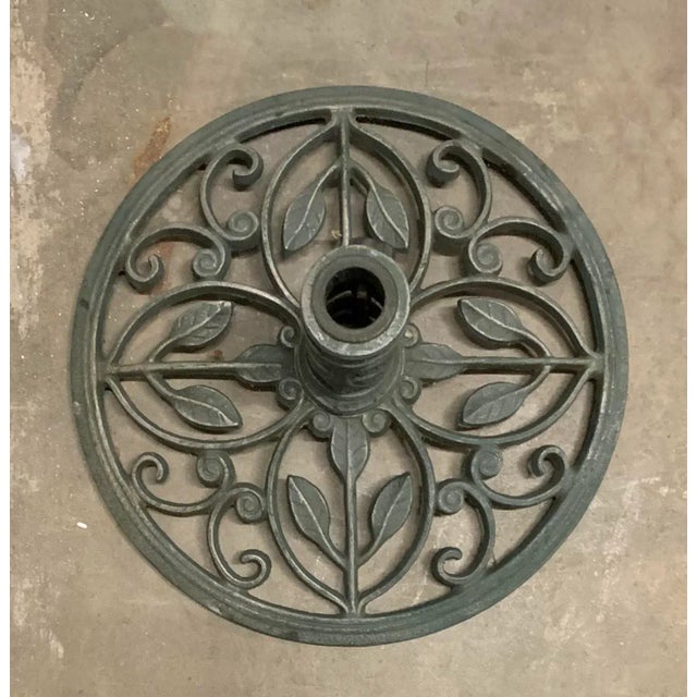 Solid metal umbrella stand with leaf design. The finish on the metal is a green patina. opening for umbrella: 1.5"dia