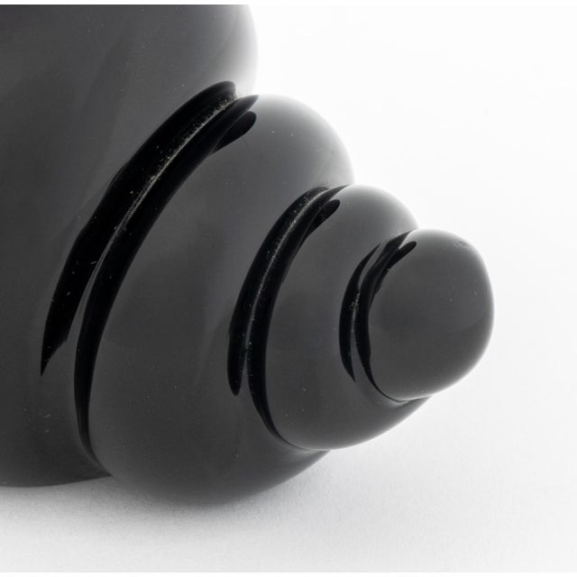 Cartier Black Glass Conch Shell Bud Vase, marked "Cartier" to underside. 2.5" H x 3" W x 4" D. Provenance: From a 500 Park...