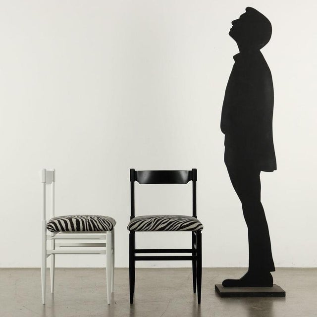 Group of six vintage chairs of Italian manufacture, exposed black and white relacquered wood and foam padding, animal-...