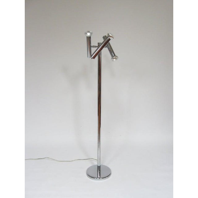 A very elegant design, this Minimalist floor lamp has three heads that can pivot and swivel to direct light up, down, or...