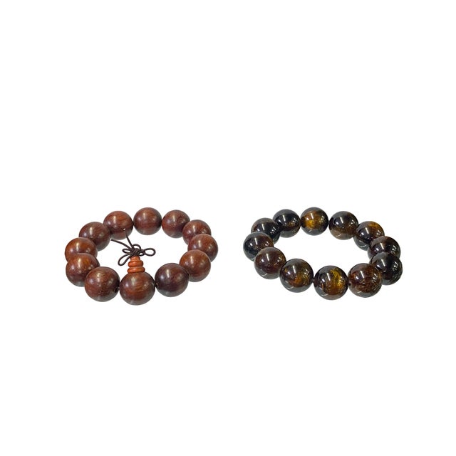 This is a set of two rosary / praying bracelets with natural reddish-brown rosewood / amber-like-resin golden brown color...