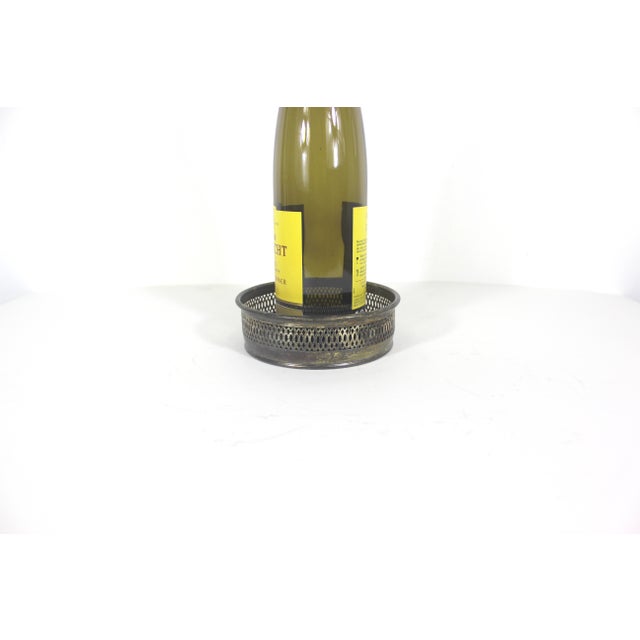 Vintage Italian silver plated wine bottle coaster with plastic faux wood base and pierced side detail. This has tarnish...