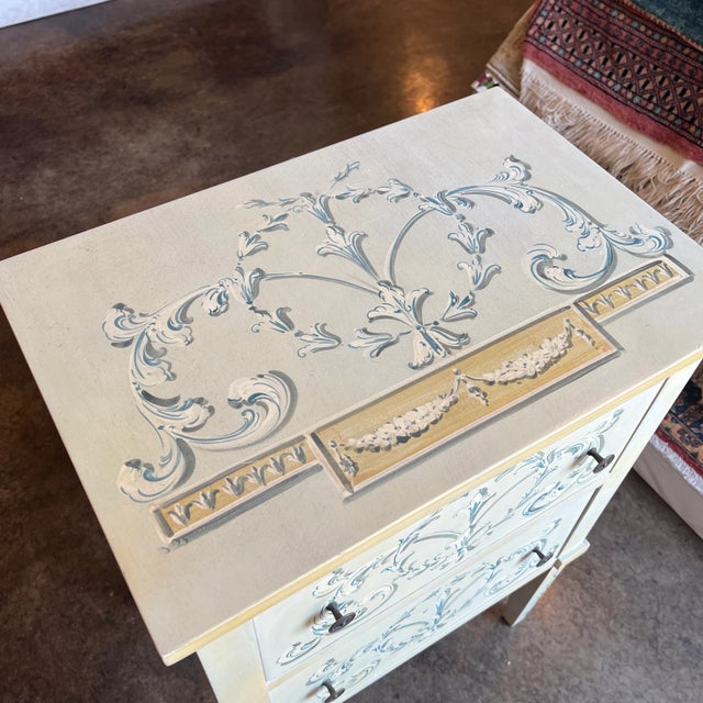 Small hand painted chest of two drawers with hidden tray on the top. Created in Italy.
