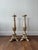 This pair of antique Baroque candlesticks is crafted from wood and adorned with gilded details, showcasing ornate period...