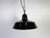 Industrial black enamel pendant light made in United Kingdom during the 1960s. White enamel inside the shade. Brass top....