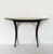 An elegant, designer entryway console table featuring clean, elegant lines. It features a half-moon top covered in fine...