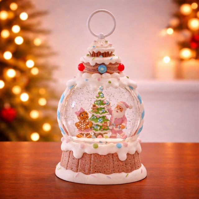 Sweeten your holiday décor with this whimsical LED Santa & Gingerbread Tree Snow Globe. Featuring Santa proudly standing...