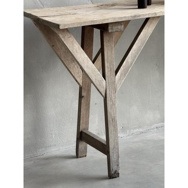 A Wabisabi Inspired Rustic Console Table. This early C20th French 'scrub' table made in poplar and ash wood, was...