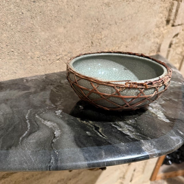 For your consideration, a ceramic bowl, likely a piece of Chinese celadon ware, characterized by its distinctive crackle...