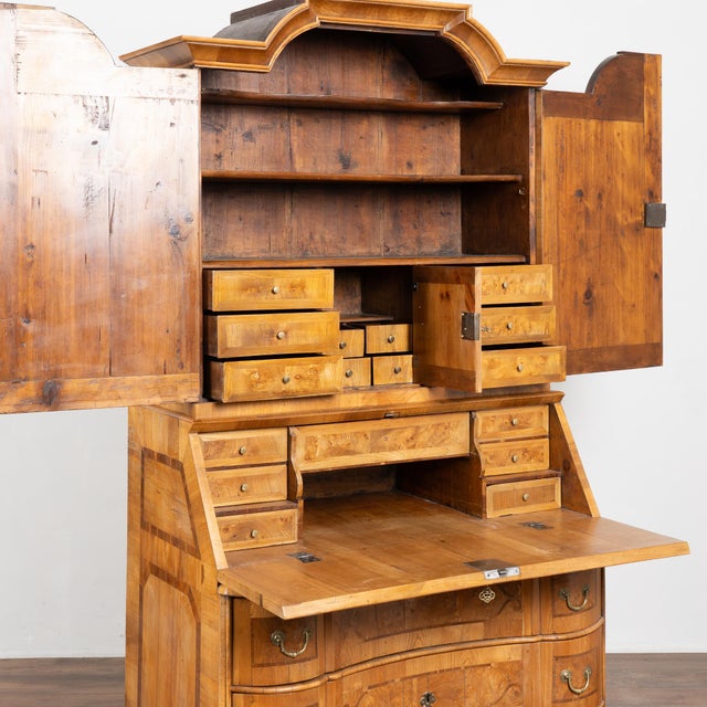 18th-century German secretary or "bureau" crafted from walnut, featuring extensive marquetry. The inlaid decoration...