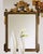 Handcrafted in Italy, this wall mirror features a solid wood frame with intricate hand-carving. The beveled clear glass...