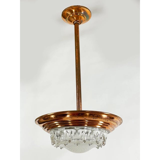 A striking and authentic French Art Deco pendant light by EZAN, dating to the 1930s. This exceptional fixture features its...