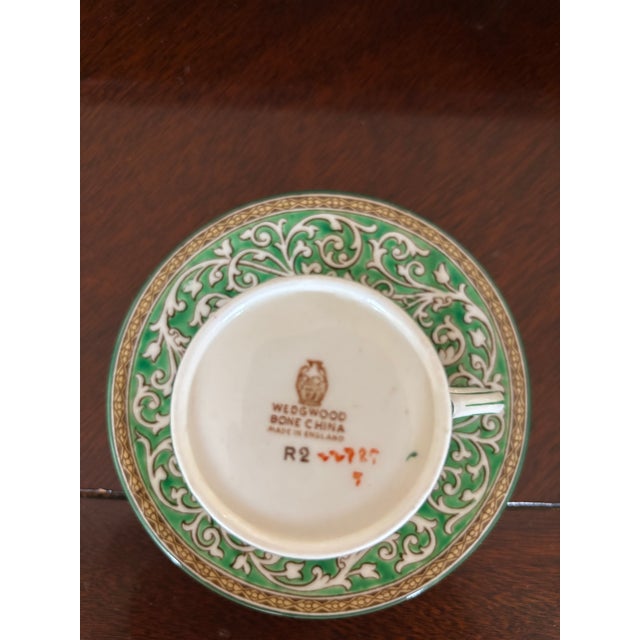 This classic vintage fine bone china demitasse cup and saucer is made by the renowned English potter- Wedgewood. It has a...