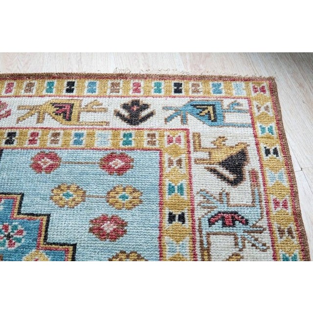 This hand knotted pile rug is crafted from wool and features a primary brown earth tone color palette. Sourced from India,...