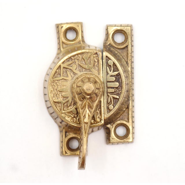 Aesthetic style decorative brass window lock with a polished finish. The original mounting screws are not available. Good...