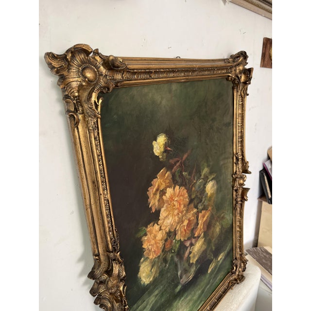 An elegant antique European still life oil painting depicting a generous bouquet of yellow and ivory roses arranged in a...