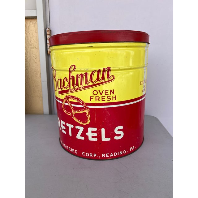 Large Vintage 1950s Bachman Oven Fresh pretzel tin. Featuring a red and yellow design. The metal canister was produced by...