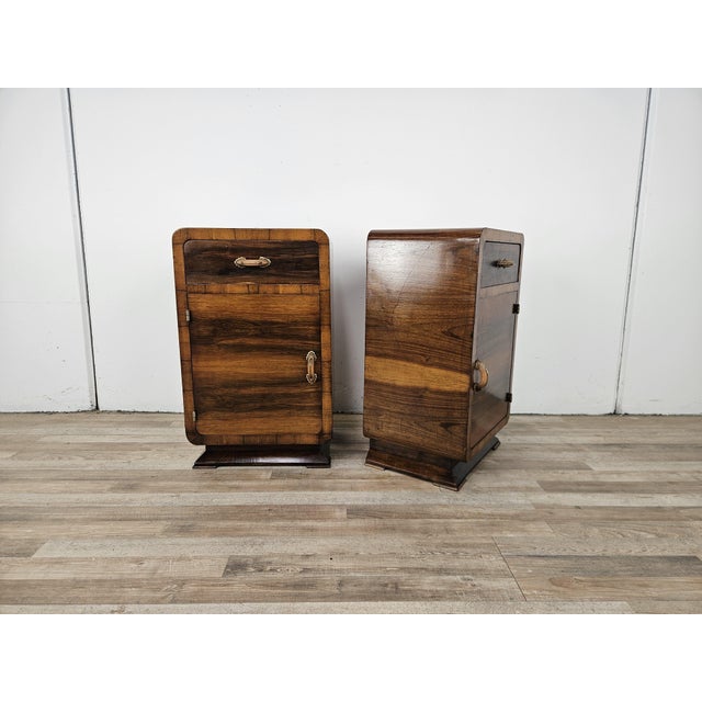 A pair of distinctive bedside tables with soft lines and slightly rounded edges, from the Art Deco period of the early...