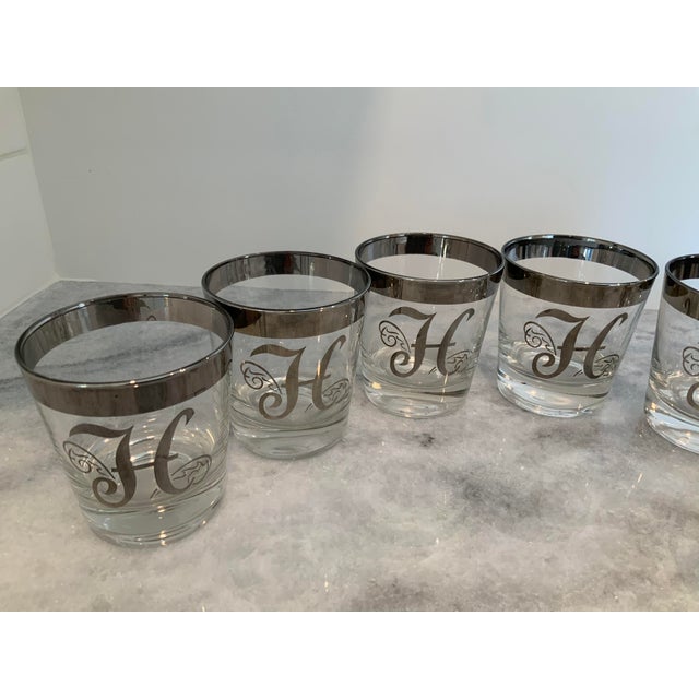 Set of 7 silver rimmed vintage “H” glasses. Dorothy Thorpe style. There is also a set of tall tumbler “H” glasses listed.