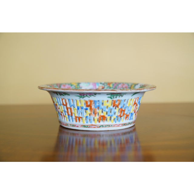 A decorative antique Chinese export famille rose reticulated porcelain basket bowl featuring pierced openwork sides,...