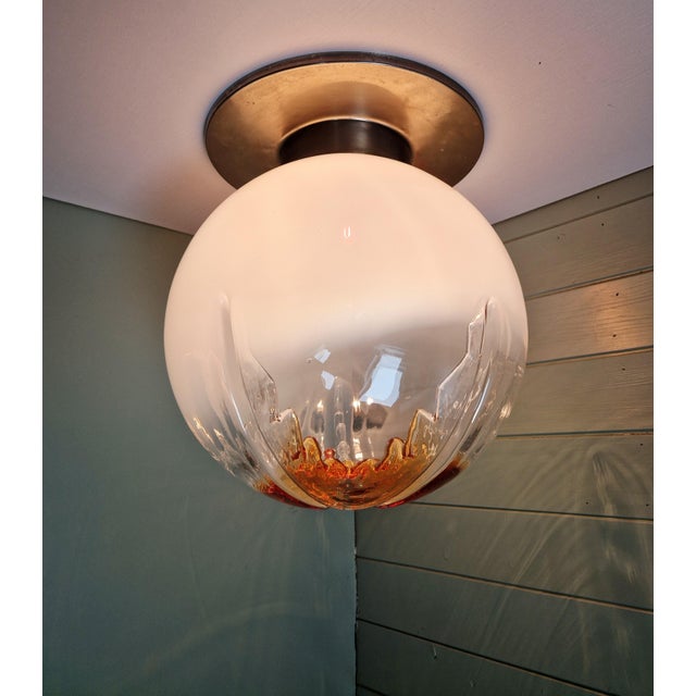 Large ceiling light composed of a chromed metal base and a murano glass globe, produced by the italian manufacturer...