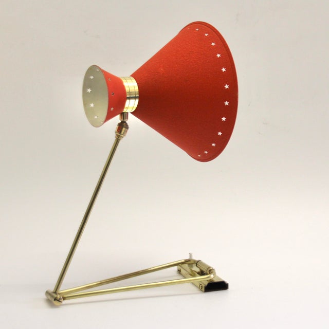 This articulated swing-arm wall light was designed by Rene Mathieu and was produced by Lunel in France. It has a double...