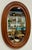 Vintage oval farmhouse style wood framed wall mirror. Features nice, rich natural wood tones with beveled frame. Age wear....