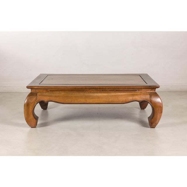 This vintage Chinese low kang coffee table features a sculptural silhouette inspired by traditional northern Chinese...