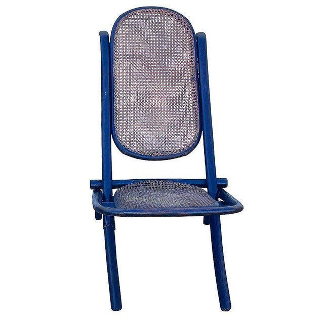 Victorian child-size Thonet number 01 folding chair with woven cane seat and backrest. It features an elegant, sculptural...