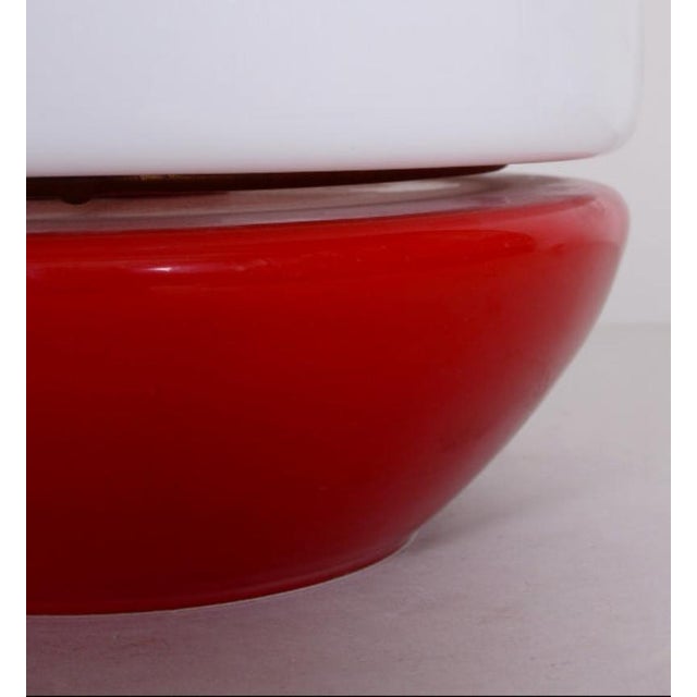 A compact mid-century table lamp with a bold mushroom silhouette and strong visual contrast. The combination of opaline...