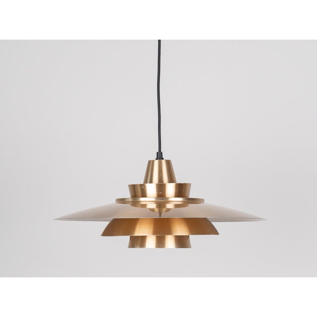A pair of vintage aluminium pendant lamps by Danish lighting manufacturer Superlight, designed by David Mogensen in the...