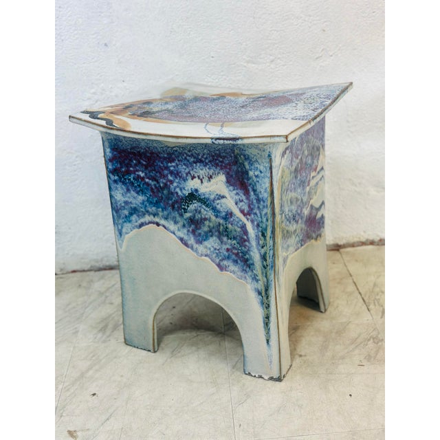 This handmade ceramic table balances architectural simplicity with richly expressive surface work. Its compact,...
