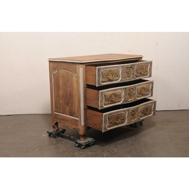 A French Louis XV period serpentine commode, with three drawers adorned with finely carved foliate decoration, from the...