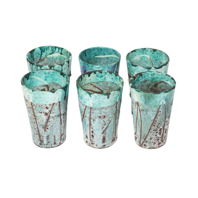 A set of six ceramic tumblers with lava glaze produced in Vallauris, France. These tumblers come in a turquoise color with...