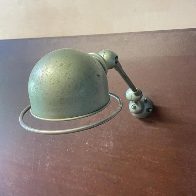 Beautiful original painted green Jielde single smaller arm wall light. Designed by the French engineer, Jean-Louis Domecq,...