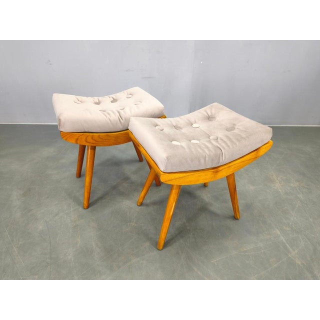 Refined pair of mid century footstools from 1960s czechoslovakia, executed in solid maple wood. The stools feature elegant...