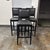 Design Plus Gallery presents a Set of Three Black Leather Barstools from Buying & Design. The black wood frames have...