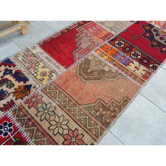 This is a vintage Turkish Oushak rug from the Mid 20th Century. The piece was hand-knotted.