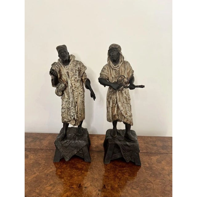 Unusual pair of antique Victorian spelter figures depicting two males in traditional moorish robes and headdresses...