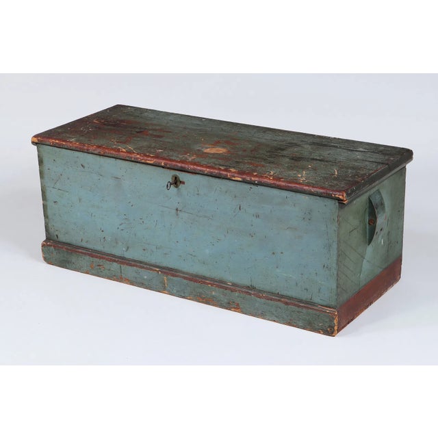 A classic 19th century sailor’s sea chest, or seaman’s box, embodying the honest utility and quiet character of maritime...