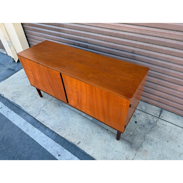 Beautiful vintage Danish modern teak credenza/cabinet from famed designer Hans Olsen. This piece exudes the classic...