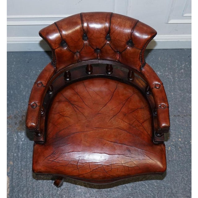 This exquisite antique hand-dyed brown leather Chesterfield captain's office swivel armchair is a stunning example of...