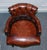 This exquisite antique hand-dyed brown leather Chesterfield captain's office swivel armchair is a stunning example of...